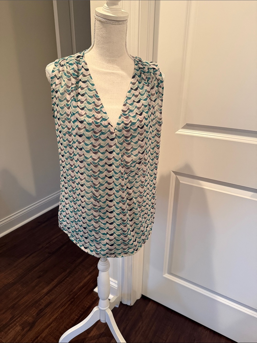 CAbi Tweet Bird Sleeveless sheer V-Neck Print Blouse in Teal